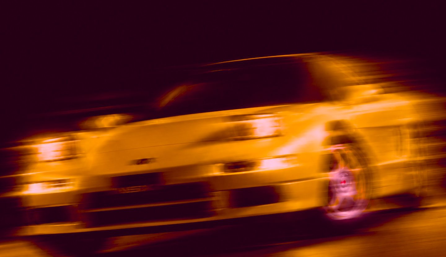 Amber light trails from a car at night