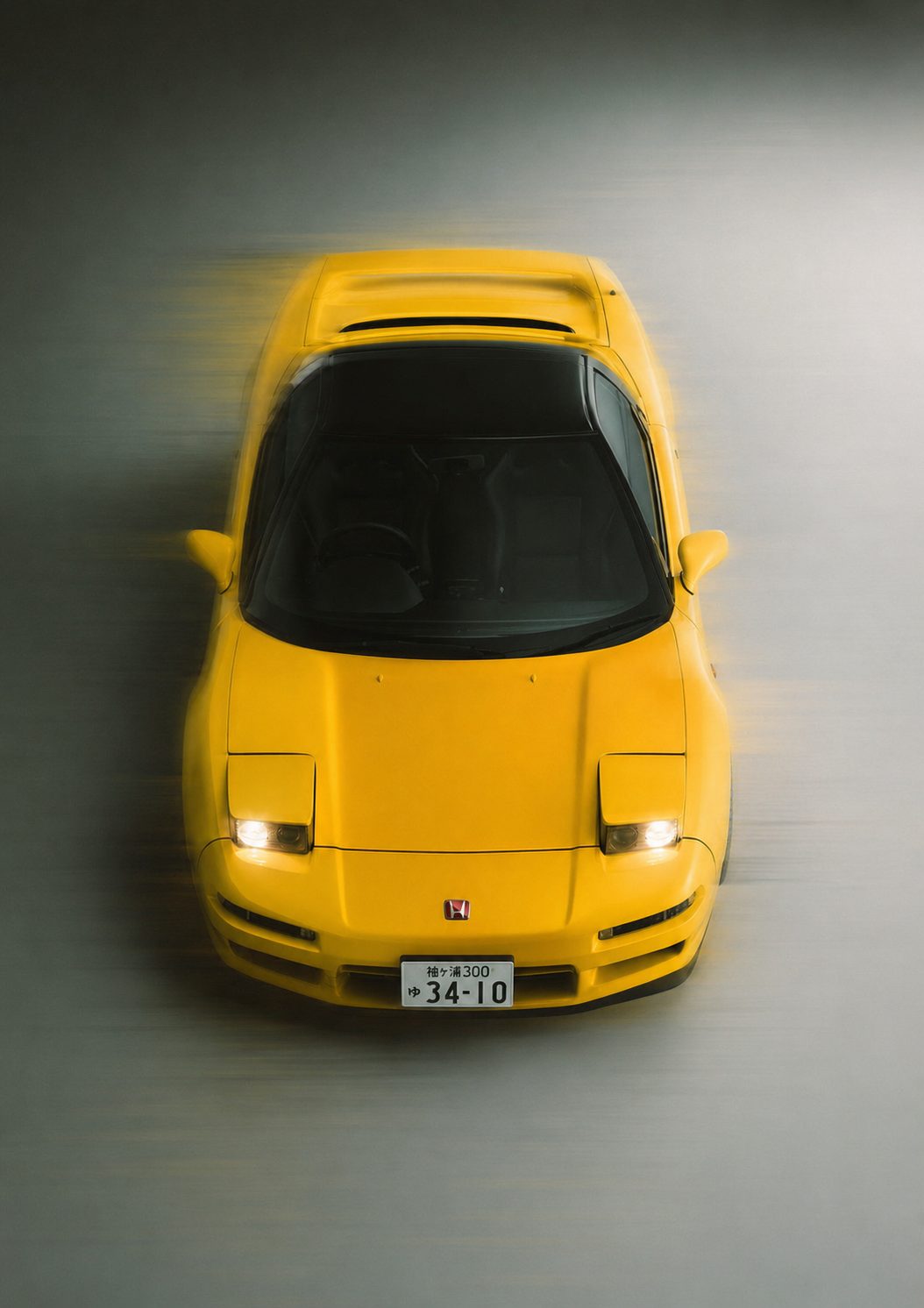 Overhead view of a yellow sports car at speed